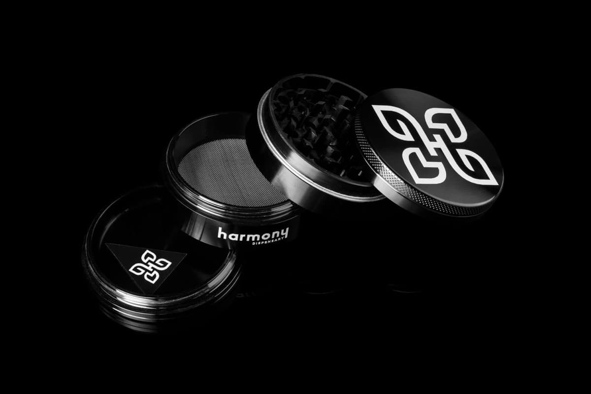 Custom grinder with silver engraved Harmony dispensary logo